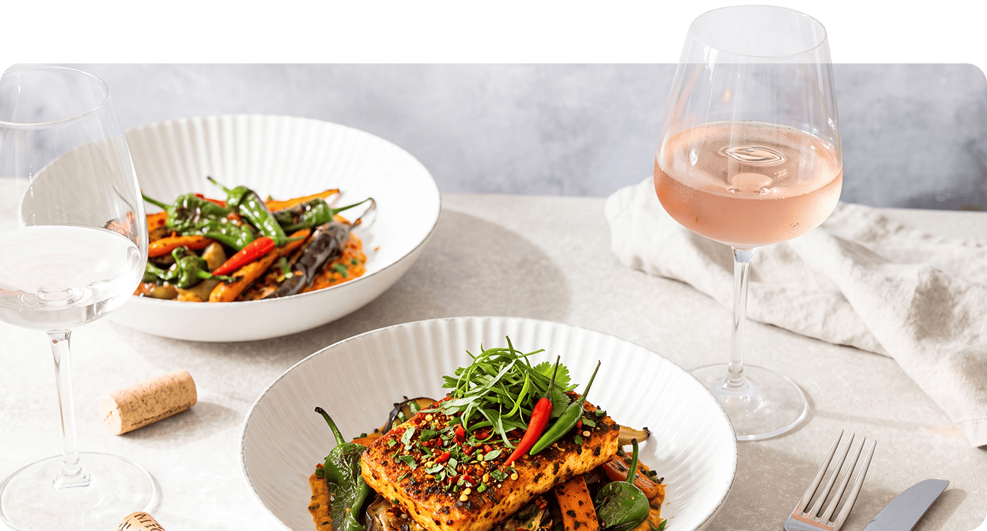 Glas rosé met een kleurrijk, pittig gerecht